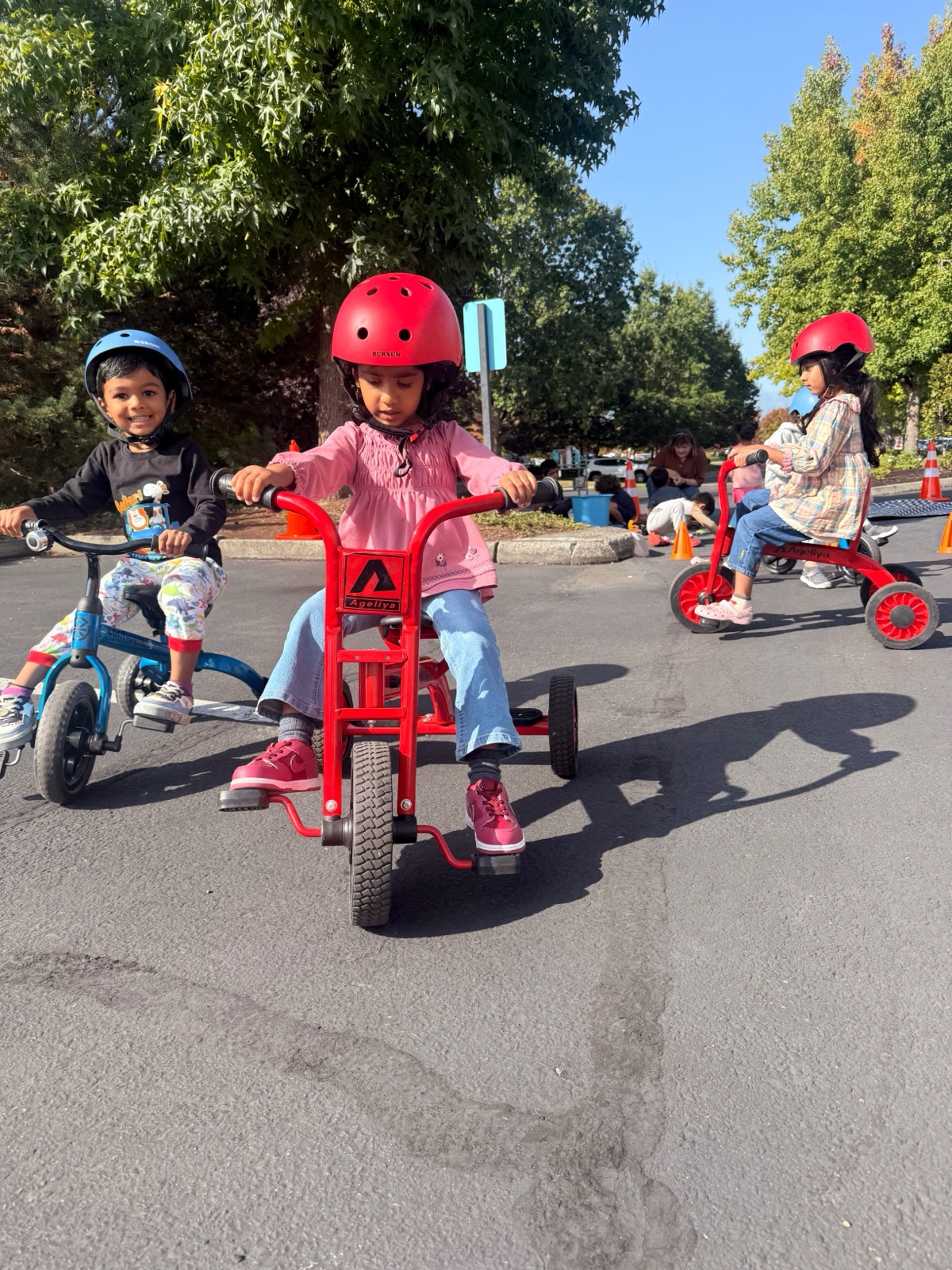 children on tricycles in the outdoor space