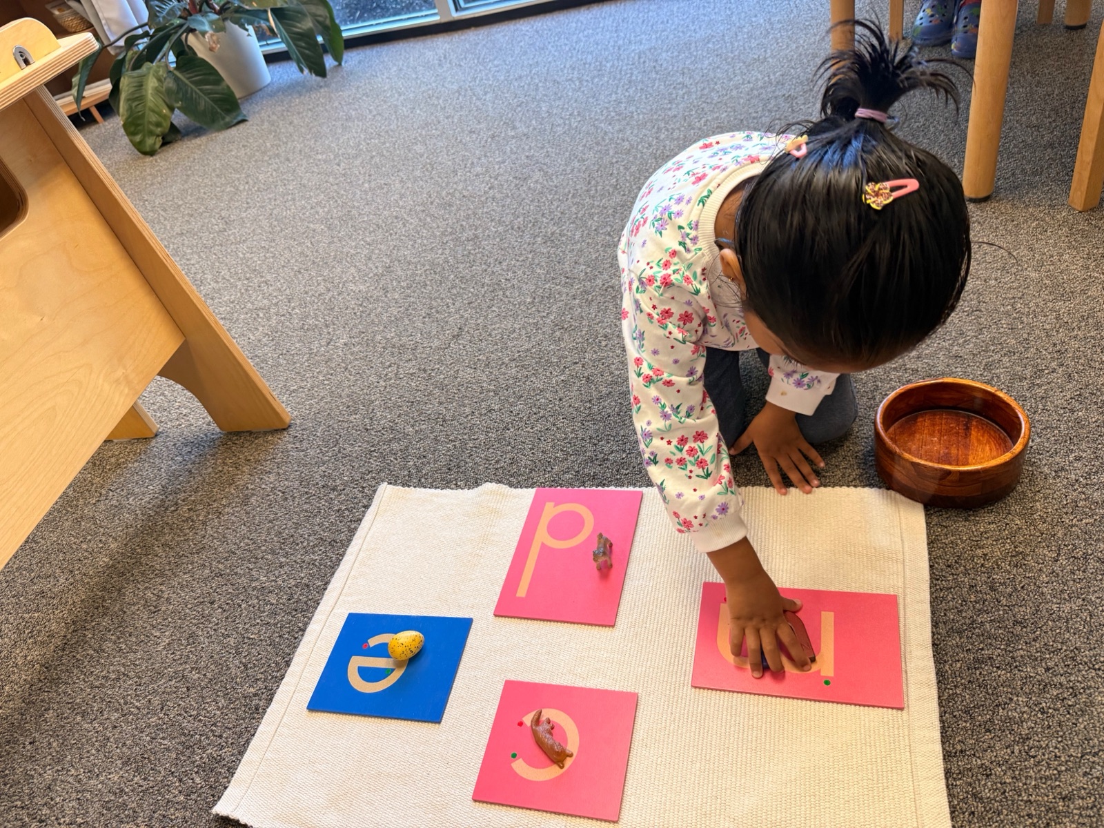 child tracing the sandpaper letters